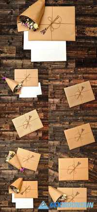 Flowers and an envelope on wooden background