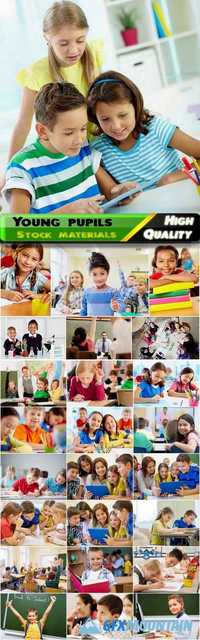 Students of the lower grades in the classroom with a teacher studying different science and lessons, kids, children, educational Stock images