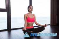 Fitness woman meditating in gym