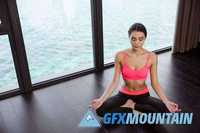 Fitness woman meditating in gym