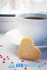 Two sponge heart and a cup of hot coffee