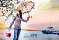 The happy woman goes with an umbrella
