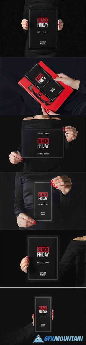 Woman in black holding paper mockup