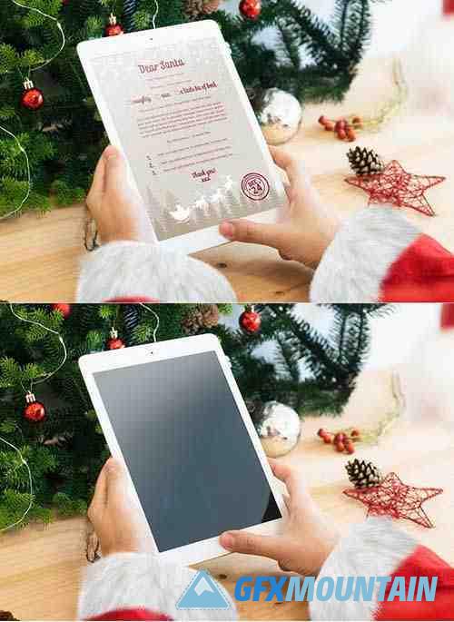 Santa Claus hands with a white tablet mockup